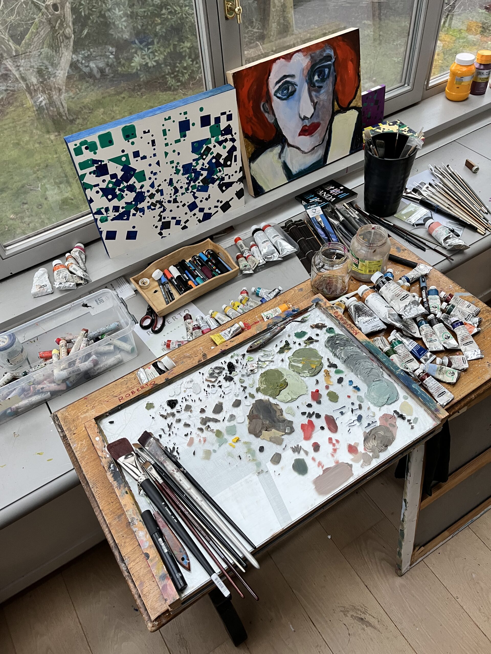 A view of my working studio, lots of Mussini Paint, brushes and pencils indisorder.